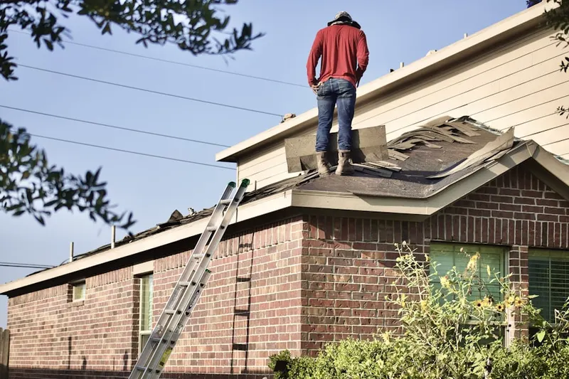 Professional roofer working on a residential roof in Downtown Milford - Harbor - Post Road South